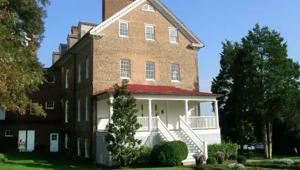 Historic brick building with a white porch, possibly related to Jefferson.