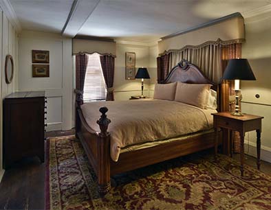 Luxurious bedroom with wooden bed, two nightstands, and decorative lamps