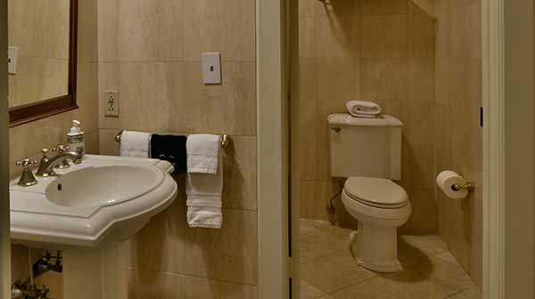 Washington Suite bathroom with pedestal sink and toilet