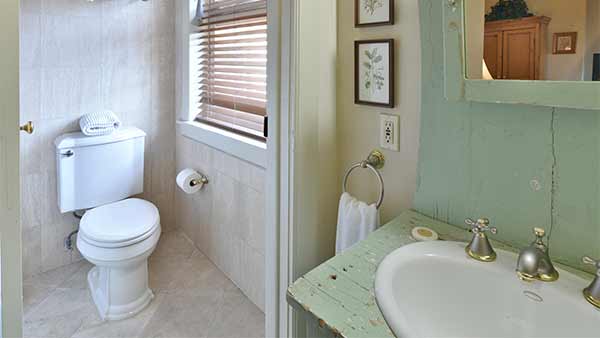 The Mary Reynolds Room: A compact bathroom with a toilet and sink.