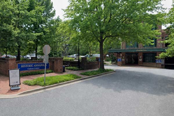 Historic Annapolis Visitors Center parking lot with blue sign and trees