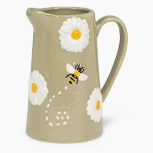 Large beige jug decorated with white daisies and a flying bee