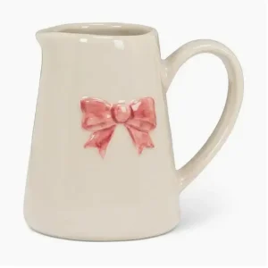 Cream mini jug with a raised pink bow detail.