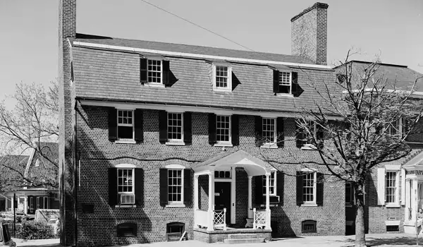 Exterior of historic Reynolds Tavern, a colonial brick building with a mansard roof.